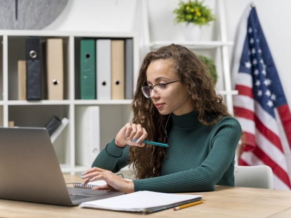 medium shot girl with laptop headphones studying